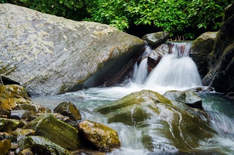 a large waterfall over a rocky cliff