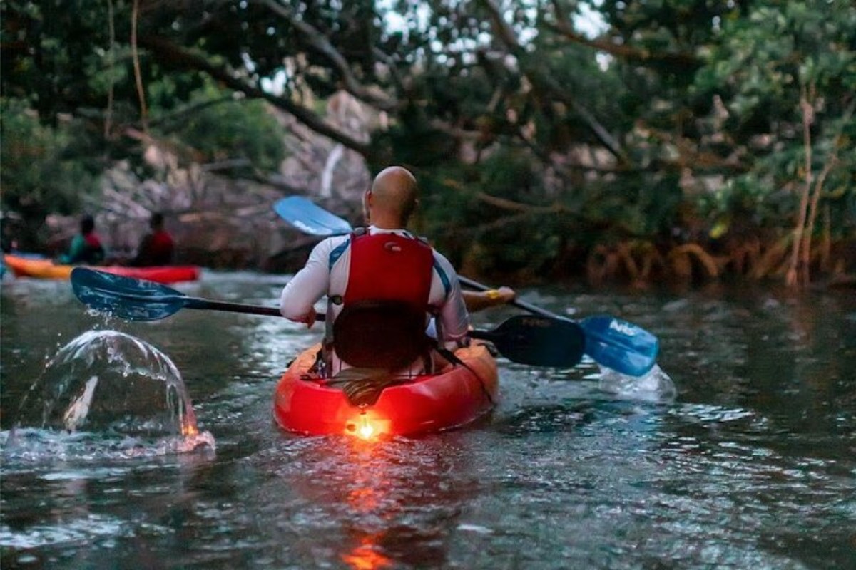 a person standing next to a body of water
